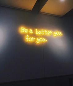 a neon sign that says be a better you for you on the side of a wall