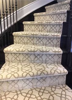 a set of stairs with carpet on the bottom and handrails in front of them