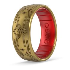 a red and gold ring with an intricate design on the inside, in front of a white background