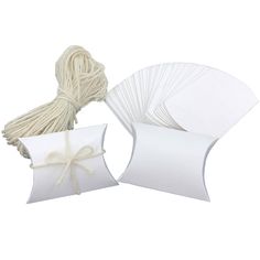 50 pieces of white paper with twine on the top and tied up to each other