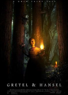 a movie poster with a man holding a lantern in the woods, surrounded by trees