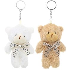 two teddy bears with bows are hanging from keychain hooks, one is white and the other is brown