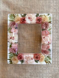 a white and pink flower frame on a table