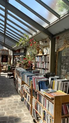 a long row of books are on display in a book store's glass roof