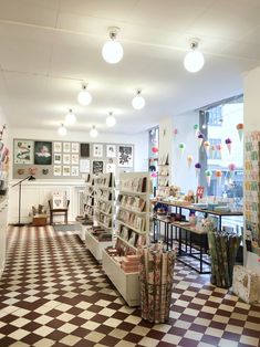 the inside of a store with checkered flooring and lots of items on display