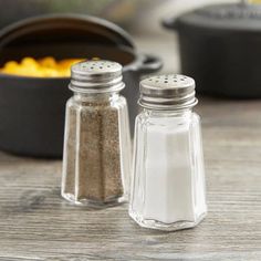 two salt and pepper shakers sitting on a table