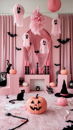 a pink room decorated for halloween with black and white decorations