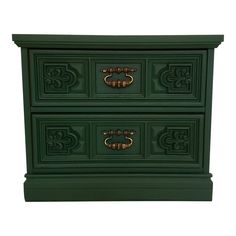 a green nightstand with two drawers and gold pulls on the bottom drawer, against a white background