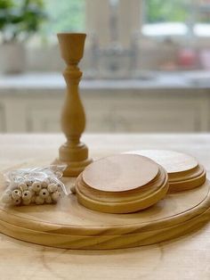 a wooden table topped with plates and a candle