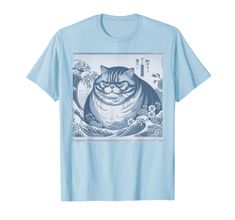 a blue t - shirt with an image of a cat in the water and waves