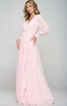 a woman in a pink dress posing for the camera with her hands on her hips