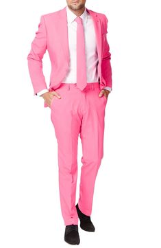 Formal style doesn't have to be rigid and boring. Thankfully, with this bright pink two-piece suit, OppoSuit goes against the grain with fun, bold personality. Tailored for a modern fit, it includes a two-button suit jacket and trousers cleanly styled with tonal buttons and stitching, as well as a matching tie to pull the whole outfit together. Jacket has a two-button closure; notch lapels; nonfunctional four-button cuffs; chest pocket; front flap pockets; side vents. Trousers have a zip fly wit Mens Pink Pants, Real Men Wear Pink, Sweet 16 Outfits, Black Suit Men, Against The Grain, Pink Two Piece, Beige Suits, Dress Suits For Men, Men Wear