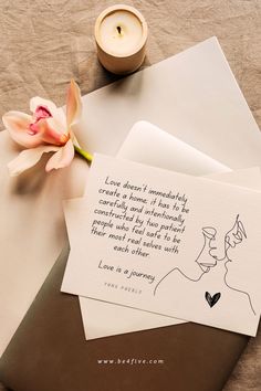 a card with a quote on it next to a flower