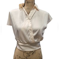 Pearl In Color This Small Faux Silk Blouse Is Elegant And Stylish. 97% Polyester/3% Spandex With A Zippered Waist It Compliments All The Right Areas. Stylish Enough For The Office, Yet Elegant Enough For A Night Out On The Town. G Elegant Cropped Cream Top, Elegant Cream Cropped Tops, Solid Collared Tops For Night Out, Chic Stretch Collared Blouse, Fitted Cropped Blouse For Office, Chic Cream Tops For Night Out, Chic Cream Top For Night Out, Elegant Stretch Cropped Blouse, Chic Collared Padded Blouse