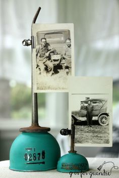 an old fashioned table lamp with two pictures on it and a blue bell shaped base