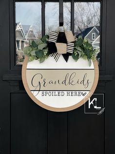 a black door with a sign that says grandkids spoiled before it is closed