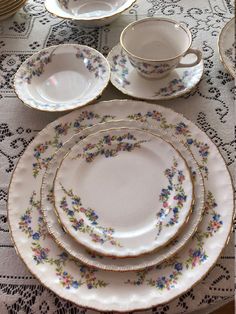 a table topped with lots of plates and cups