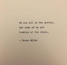 an old typewriter with the words we are all in the gutter, but some of us are looking at the stars