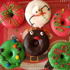 there are many decorated doughnuts on the tray