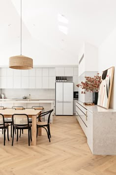 an open kitchen and dining room with white walls