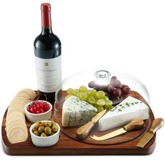 a wine bottle and some cheeses on a tray