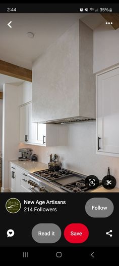 a kitchen with white cabinets and an appliance on the phone showing it's location