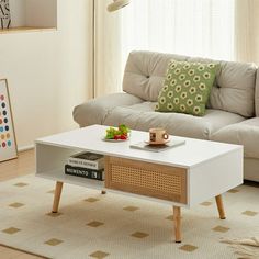 a living room with a white couch and coffee table