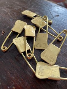 several pieces of gold metal sitting on top of a wooden table