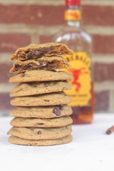 a stack of cookies sitting next to a bottle