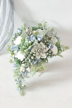 a bridal bouquet with succulents and greenery