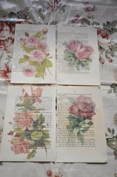 four cards with flowers on them sitting on a tablecloth covered bed spread in floral designs