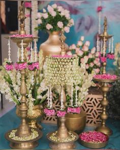 a table topped with lots of vases filled with pink and white flowers next to each other