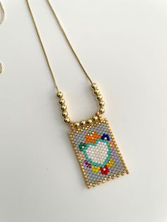 a beaded necklace with a heart on it