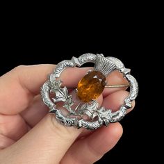 "Signed Mizpah Scottish thistle brooch. Citrine glass gem, with silver tone metal. Good vintage condition, with some wear to the rhinestone, as shown in photos. 1.85\" inches by 1.5\" inches. A lovely Scottish Christmas Holiday Birthday gift for that special someone. Great accessory for a Scottish wedding. Contact me for combined shipping." Antique Hallmarked Brooches For Wedding, Antique Hallmarked Wedding Brooches, Heirloom Oval Brooches For Wedding, Silver Oval Brooches For Wedding, Antique Wedding Brooches, Silver Oval Wedding Brooches, Victorian Brooch Pins For Wedding, Victorian Wedding Brooch Pins, Hallmarked Oval Brooches For Wedding