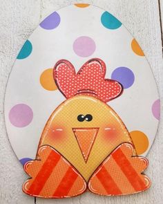 a paper cut out of a chicken with polka dots on it's back ground