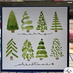 a card with watercolor christmas trees on it