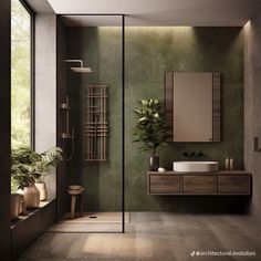 a modern bathroom with green walls and wood flooring is pictured in this image, there are plants on the counter