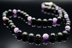 Men's Amethyst Necklace Crystal Necklace Gemstone Beaded Necklace Gift for Men Hand Knotted Necklace Onyx Necklace Black Agate Necklace The handmade necklace is made of 8 mm natural Amethyst beads (purple), 8 mm natural Agate beads (black), and 8 mm natural Onyx beads (black matte).  The Necklace is hand-knotted and closed with stainless steel lobster claw clasp.  - Necklace length 51 cm (2o inches). - Shipping Worldwide from Munich, Germany. - The necklace will look perfect with these bracelets: https://www.etsy.com/listing/569456912/amethyst-bracelet-for-men-beaded?ref=shop_home_active_7 https://www.etsy.com/listing/549178268/mens-amethyst-bracelet-gemstone-bracelet?ref=shop_home_feat_1 - if you want to see my other items click https://www.etsy.com/your/shops/Valinde/tools/listings Thank Black Amethyst Gemstone Beads Jewelry, Black Amethyst Beads Jewelry 8mm, Black Amethyst 8mm Bead Jewelry, Onyx Necklace With 8mm Round Beads, Black Amethyst Gemstone Beads Necklace, Onyx Bead Necklaces With 8mm Round Beads, Onyx Bead Necklace With 8mm Round Beads, Black Beaded Amethyst Jewelry, Black Amethyst Jewelry For Formal Occasions