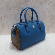 Coach Leather & Signature Canvas Rowan Satchel (Cj59) Bright Blue Leather Accented With Khaki Signature Coated Canvas. Zip Closure. Interior Zip And Slip Pockets. Exterior Zip Pocket. Handles With 4.5" Drop. 23" Adjustable Shoulder Strap. Silver Hardware. 10.5" (L) X 6.25" (H). Coach Rogue, Coach Satchel, Black Leather Satchel, Satchel Tote Bag, Leather Satchel Bag, Satchel Tote, Signature Canvas, Tote Bag Purse, Satchel Purse