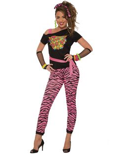 a woman in pink zebra print pants and black top with her hands on her hips