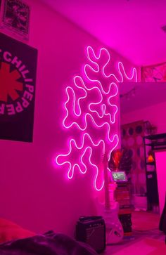 a pink room with neon lights in the corner