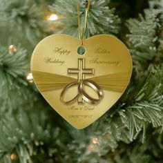 a heart shaped ornament with two wedding rings on it