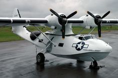 an airplane sitting on top of a wet runway