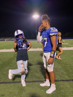 two young football players standing on the field