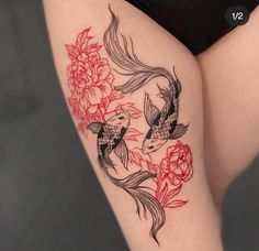 a woman's thigh with koi fish and flowers on it