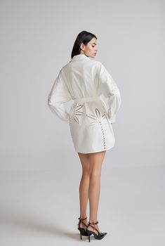 The Lani White Short Shirt Dress is an ethereal breezy style from the Resort'24 Collection. Armed with the versatility of white and the comfort of cotton poplin, the dress features Battenburg lace embroidery, a shirt collar with a button-down closure., and full sleeves with a cuff. Oozing casual elegance, the dress gently curves at the hem and cinches at the waist with a tie-up belt. A perfect style for champagne brunches! Made In India White Embroidered Cotton Poplin Shell - 100% Cotton Curved Short Shirt Dress, Curved Hem Shirt, Breezy Style, Battenburg Lace, Hemant And Nandita, Short Shirt, Perfect Style, Lace Embroidery, Full Sleeves