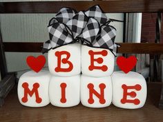 a stack of blocks that say be mine with hearts on them and the words be mine spelled out in red