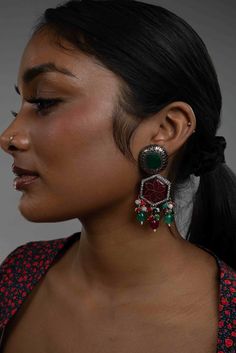 Elevate your elegance with the Ruby Green CZ Zahra Earrings in Black Polish. These exquisite earrings feature a stunning ruby carved stone surrounded by sparkling CZ, with a vibrant green stone at the top. The black polish finish adds a contemporary touch, while the dangling ruby, green, and multicolor Monalisa stones create a mesmerizing effect. Perfect for any special occasion, these earrings blend the richness of Pakistani jewelry and Indian jewelry traditions. Embrace the timeless charm of D Red Fusion Style Earrings For Party, Fusion Style Dangle Earrings For Party, Fusion Dangle Earrings For Party, Fusion Style Drop Earrings Danglers For Party, Fusion Style Drop Danglers For Party, Fusion Style Drop Earrings For Party, Pakistani Earrings, Oxidized Earrings, Pakistani Jewelry