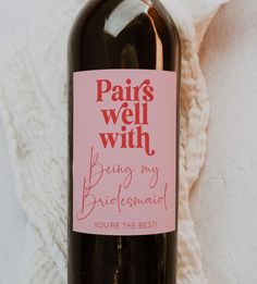 a bottle of wine with a pink label on it that says paris well with being my bridesmaid you're the best