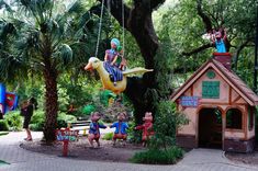 children are playing in an amusement park with swings and floats, including a ducky